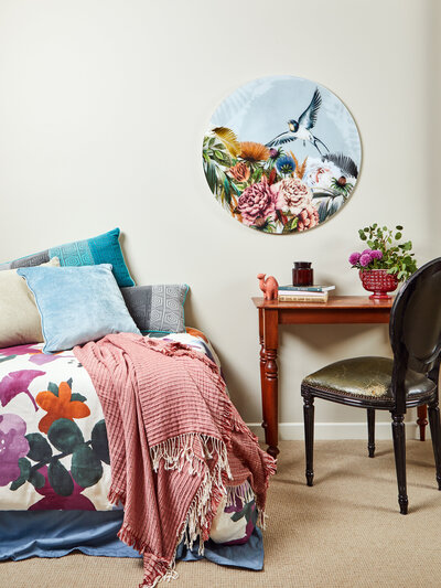Playful bedroom with floral bedding, pastel accents, and curated artwork styled by Melbourne interior stylist Lisa Hunter.