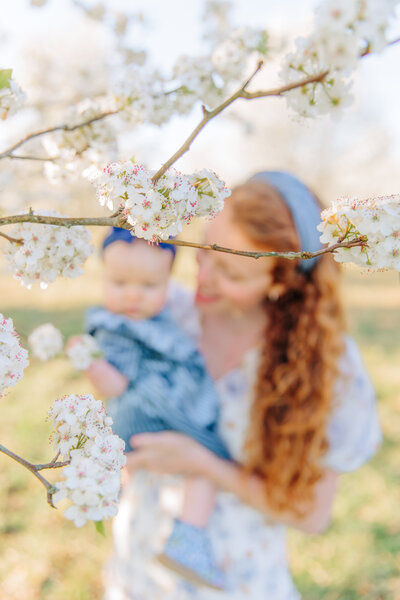 Asheville Motherhood Photographer photographs mom and baby in the Spring blooms in Fletcher, NC
