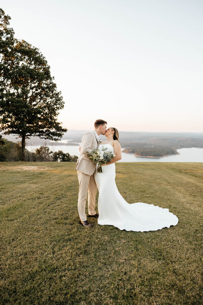 Bride and Groom walk alongside shoreline