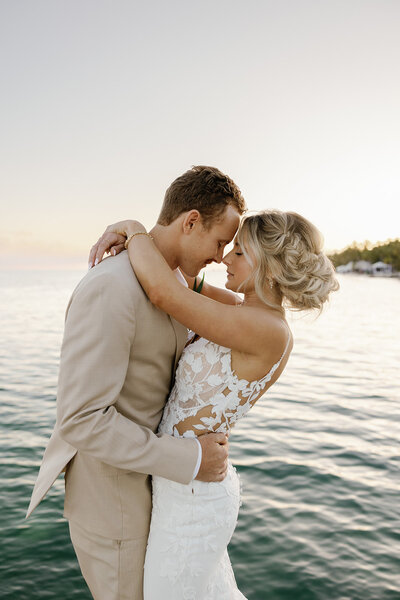 Bride and groom kissing at Cheeca Lodge Resort with their dogs, captured by Claudia Amalia, a wedding and lifestyle photographer based in Miami and Florida Keys, South Florida. Destination weddings available. Portfolio highlight.