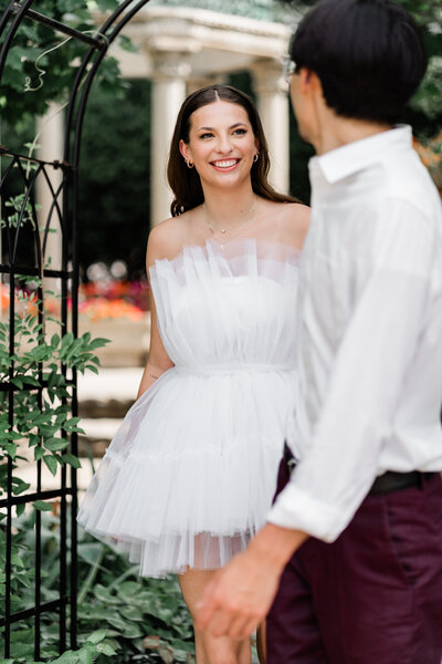 bride and groom looking at one another smiling