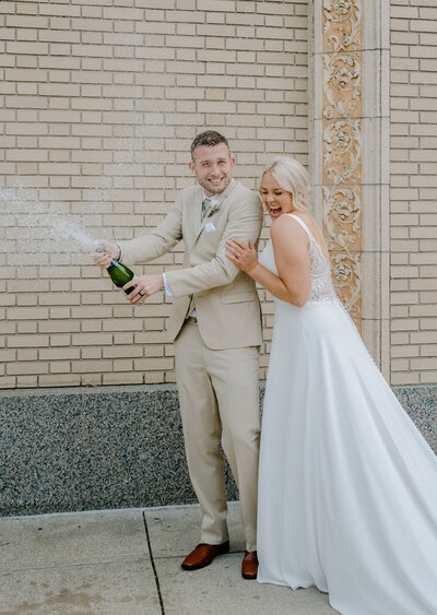 A newly married couples celebrating in Grand Rapids with their  West Michigan wedding photographer