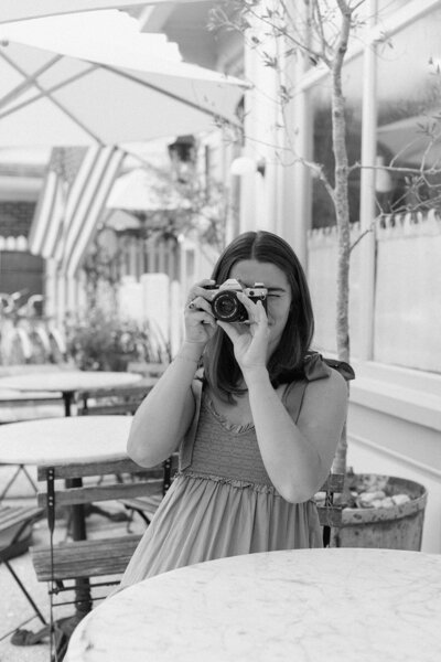 Caroline Keown, Photographer, takes a photo on her film camera