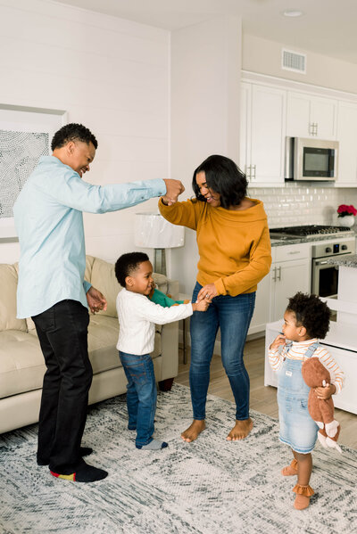 Woman dancing with her husband and two children
