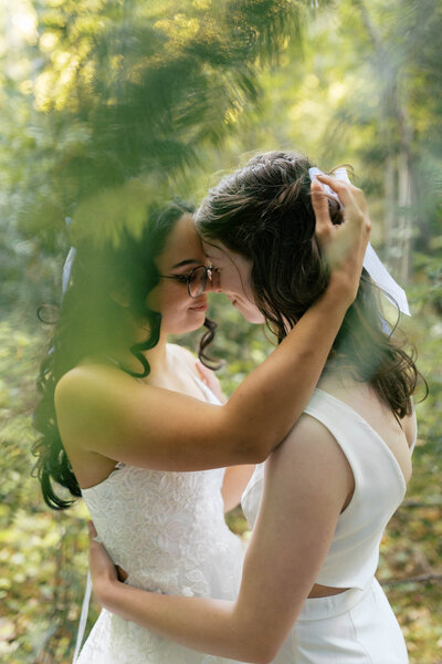 Emotional close-up of bride and groom sharing a quiet embrace at their Tri-Cities vineyard wedding.