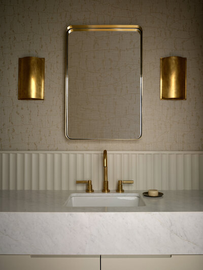 embroidered-wallpaper-warm-cozy-bathroom-powder-room-brass-kelly-wearstler-sconces-fluted-backsplash-carrara-marble-countertop-vanity-brass-faucet-austin-design-house-franc