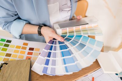 Image of a person holding a paint deck fan in the blue color scheme section