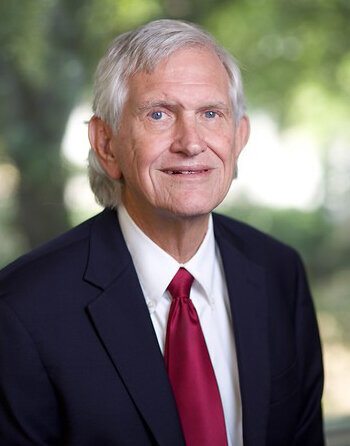 Attorney Thomas F. McDow of McDow & Urquhart LLC standing outside the Rock Hill, SC courthouse, smiling in a professional portrait.
