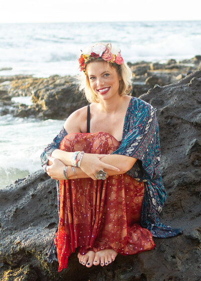 woman  wearing patterned outfit on rocky beach