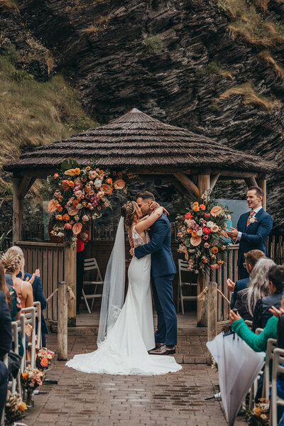 couple share their first kiss in the rain