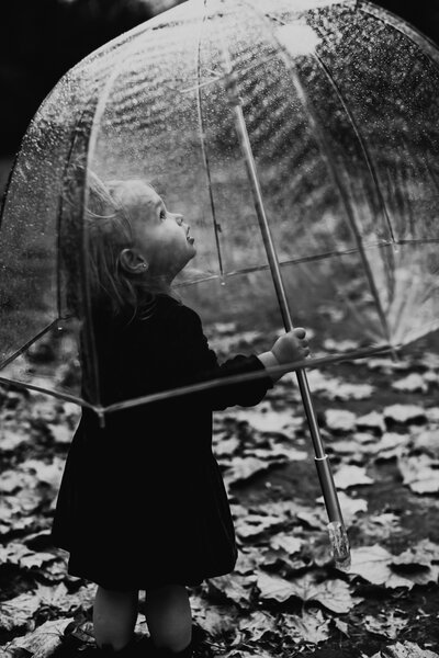 little kid holding an umbrella
