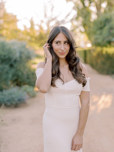 Jessica Kay, photographer, standing in a lush garden setting