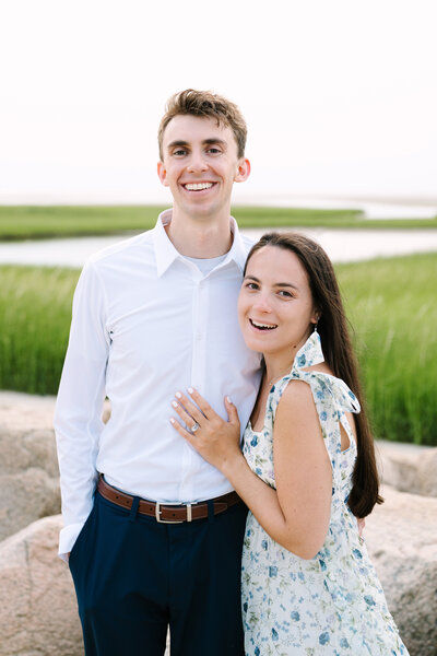 couple smiling at the camera during their paine's creek brewster massachusetts sunset engagement session