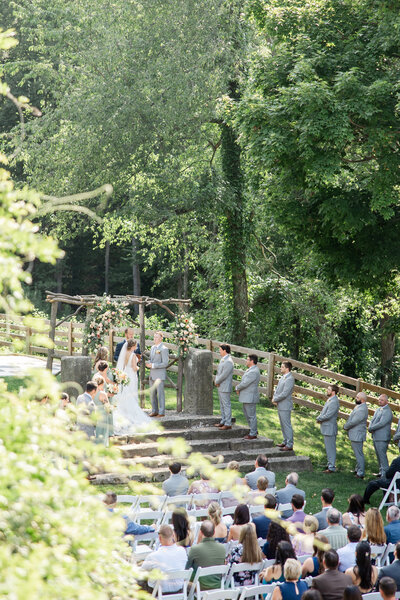 Bride and groom sitting on a tree swing at their summer Rivercrest Farm wedding photographed by akron ohio wedding photographer