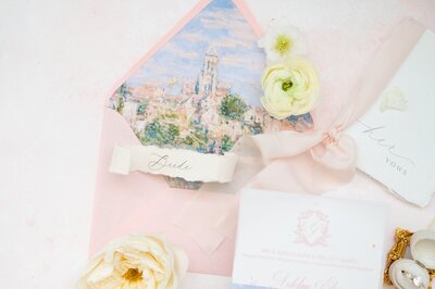 A romantic, Italian inspired flat lay with a pink envelope.