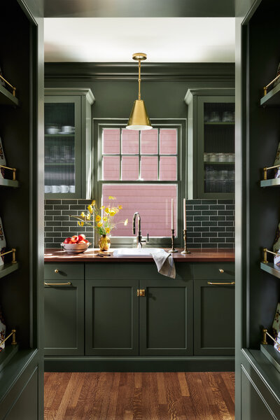 Bold cabinets and beautiful molding in kitchen design by Kira David Design