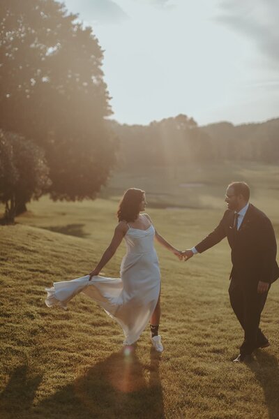 Bride and groom dance in golf course