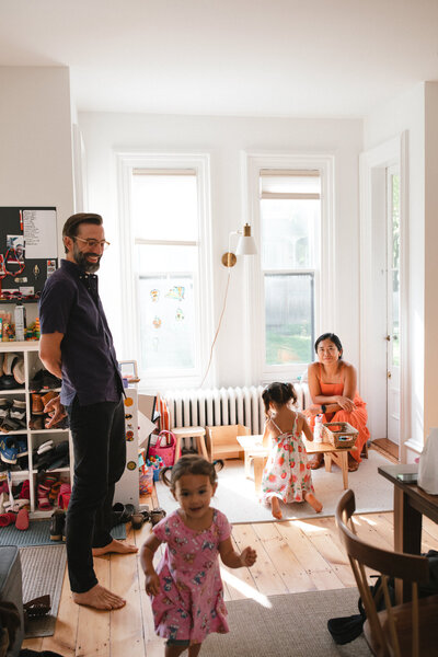 nyc family portrait with kids painting and running in playroom