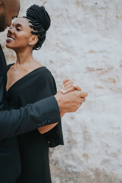 Black couple wearing black clothes and dancing