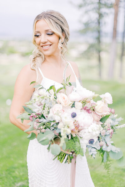 The bride holds her wedding bouquet in Lake Tahoe.