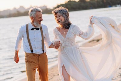A couple enjoying their vow renewal on the beach.