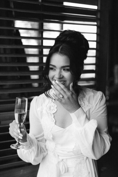 bride holding drink and smiling taken by photographer in marco island
