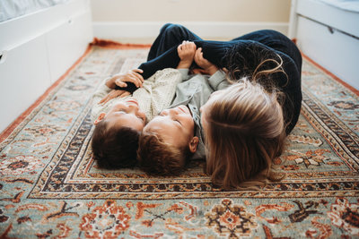 kids giggling on a rug