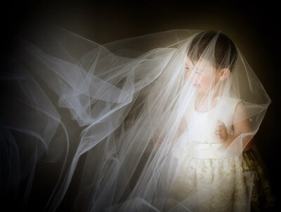 flower girl playing with veil at Emu Park Wedding
