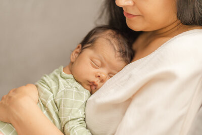 close up of baby's face while sleeping on mom during Arlington, Virginia newborn session