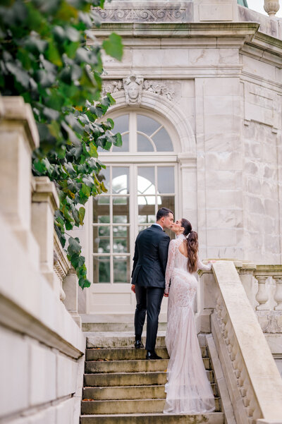 A couple kissing during their wedding at The Elms Mansion in Newport Rhode Island