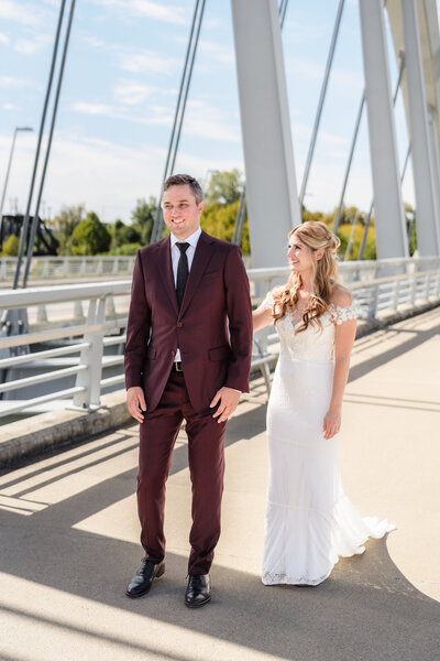 A bride and groom laugh as they exit their wedding ceremony