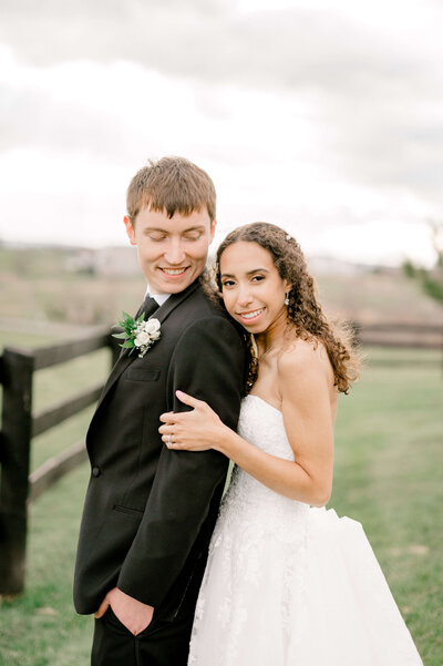 Bride and Groom snuggled close at shadow creek for wedding photos
