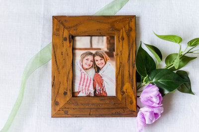 A framed image of two sisters as a gift to their mother by Laramee Love Photography