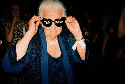 Flash photo of grandma posing with sunglasses on
