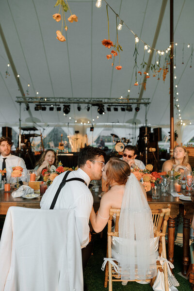 Outdoor wedding at Boyne Mountain Beach House featuring a tented reception with a lakeside backdrop