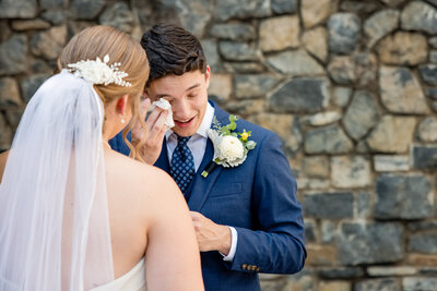 Groom wipes his teary eyes at the altar