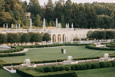 longwood gardens is the perfect philadelphia area wedding reception area. a groom and bride walk through the italian water garden holding hands. image by philadelphia wedding photographer emily wilkerson