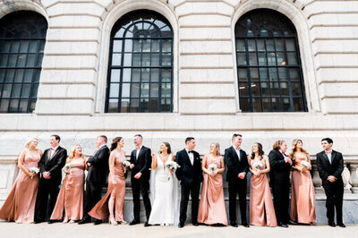 bride and groom with bridal party in front of the Cleveland Public Library