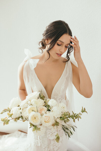 A woman in her wedding dress holding her bouquet