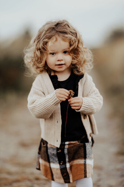 Girl toddler in beige cardigan