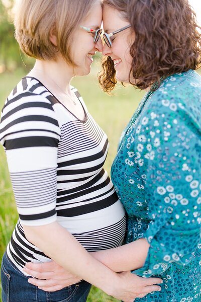 A beautiful LGBTQ+ maternity session of two moms with their heads together at Talon Winery in Lexington KY.