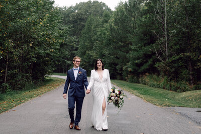 Bride and groom walking hand in hand, smiling during their Richmond backyard wedding.