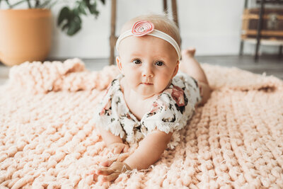 A little one shows off her new milestone during a studio petite session at the state street studio of Nikii Pix in Bismarck, ND