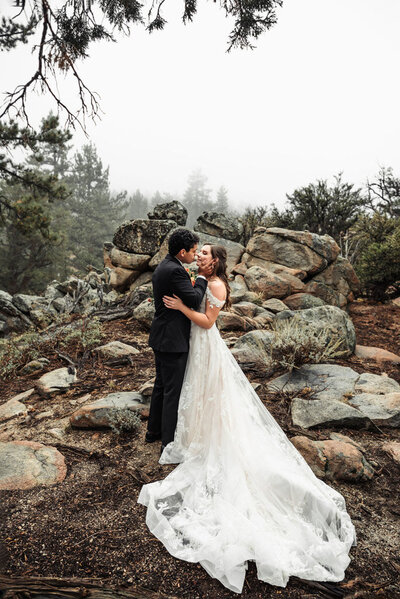 bride and groom embrace at their stunning mountain wedding
