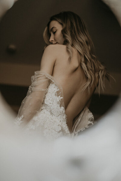 girl taking off wedding dress at Maple Ridge boudoir studio