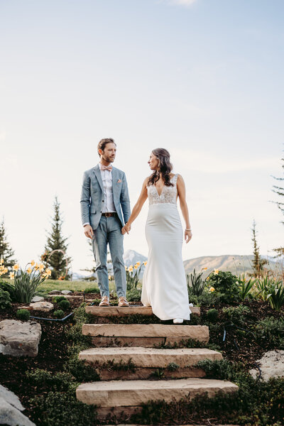 Couple poses in front of a misty mountain in Crested Butte , Colorado.