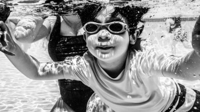 child smiling underwater