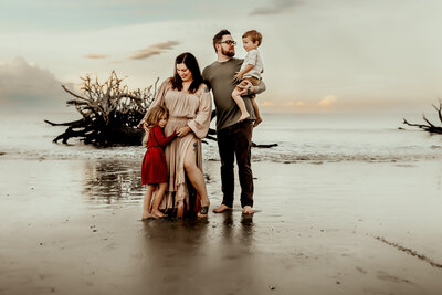 candid family on driftwood beach  captured by family photographer in warner robins ga