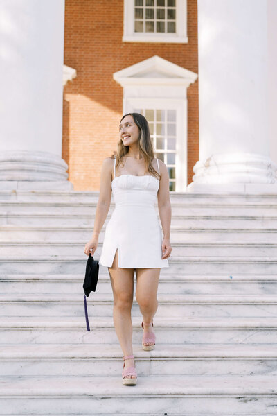 College senior walking down campus steps