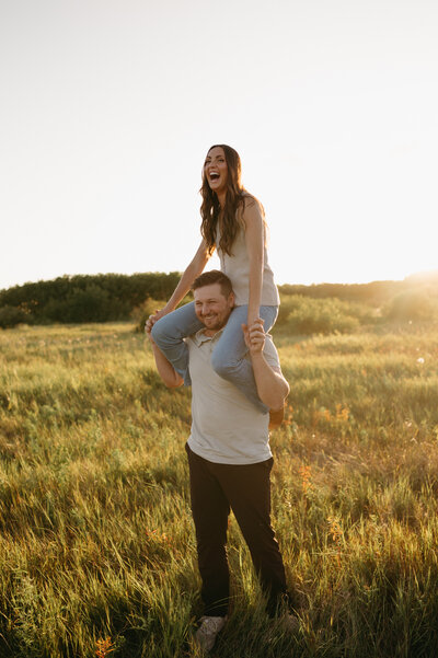 Couples session in field at sunset
